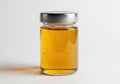 A jar of golden honey displayed against a white background Royalty Free Stock Photo