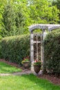 Arched wooden arbor trellis in a ornamental garden Royalty Free Stock Photo