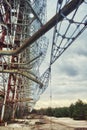 The image shows a large, decaying metal structure in an open area with sparse vegetation, under an overcast sky Royalty Free Stock Photo