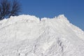 Large pile of snow after a winter storm with blue sky