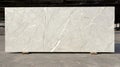 A large white marble slab with a rough texture and visible cracks. Royalty Free Stock Photo