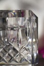 Macro abstract background of a beautiful modern hand-cut lead crystal glass candle holder with diamond shape cuts Royalty Free Stock Photo