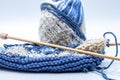 Skein of blue and white yarn and knitted cloth