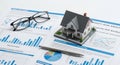 property risk analysis with model house and charts Royalty Free Stock Photo