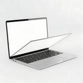 A sleek silver laptop with an open lid and visible keyboard on a plain background Royalty Free Stock Photo