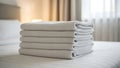Neatly folded stack of white towels on a bed Royalty Free Stock Photo