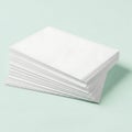 A stack of white perforated paper sheets on a light green background Royalty Free Stock Photo