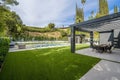 Image shows an outdoor patio overlooking a stunning swimming pool