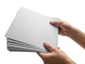 A pair of hands holding a stack of white printer paper against a white background Royalty Free Stock Photo