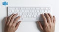 Typing on a white computer keyboard with human hands overhead view Royalty Free Stock Photo