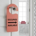 Occupied and available bathroom sign on a door with towels visible inside Royalty Free Stock Photo