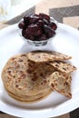 warm aloo paratha served with sweet dates. Royalty Free Stock Photo