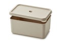 A beige plastic container with a hinged lid on a white background is visible Royalty Free Stock Photo