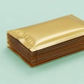 Gold-colored rectangular object with brown sides on a green background Royalty Free Stock Photo
