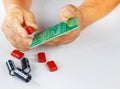 The image shows a red electronic component, likely a capacitor or resistor, being held in hand for assembly on a green printed Royalty Free Stock Photo