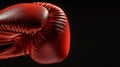 Vintage red leather boxing glove with laces on black background, retro sports gear. Royalty Free Stock Photo