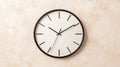A black and white clock on a beige wall. Royalty Free Stock Photo