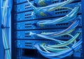 Organized network switches with color-coded ethernet cables in server rack Royalty Free Stock Photo