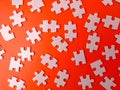 The image shows several pieces of a jigsaw puzzle on a orange background Royalty Free Stock Photo
