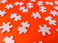 The image shows several pieces of a jigsaw puzzle on a orange background Royalty Free Stock Photo