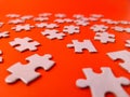 The image shows several pieces of a jigsaw puzzle on a orange background Royalty Free Stock Photo