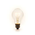 A classic incandescent light bulb with a glowing filament inside Royalty Free Stock Photo