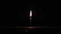 A single lit candle in the darkness. Royalty Free Stock Photo