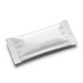 A single, sealed, and empty white packet lying on a white background Royalty Free Stock Photo