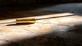 A bullet laying on a concrete floor. Royalty Free Stock Photo