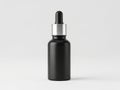 Elegant black dropper bottle with a sleek metallic cap against a plain background Royalty Free Stock Photo