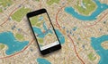 smartphone displaying map rests on colorful city map, with various landmarks and streets visible.