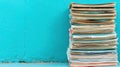 A stack of old, worn papers against a bright blue wall. Royalty Free Stock Photo