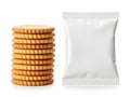 A stack of golden crackers beside an empty packaging bag isolated on white background Royalty Free Stock Photo