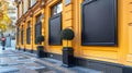 The image shows three black empty frames on the yellow wall of a building Royalty Free Stock Photo