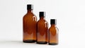 Three amber glass bottles of varying sizes arranged in descending order Royalty Free Stock Photo