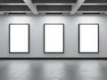 Three empty picture frames on a white gallery wall with a concrete floor isolated on white background Royalty Free Stock Photo