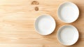 Three empty white plates on a wooden table. Royalty Free Stock Photo