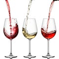 Three wine glasses being filled with different colored liquids in an elegant display Royalty Free Stock Photo