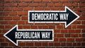 Democratic way and Republican way signs on a brick wall showing two political directions Royalty Free Stock Photo