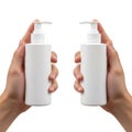 Two hands holding identical white pump bottles against a plain background Royalty Free Stock Photo