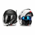 The image shows two motorcycle helmets side by side. The helmet on the left is black with a clear visor and a microphone attached Royalty Free Stock Photo