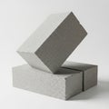 The image shows two rectangular concrete blocks with a speckled gray texture, stacked one on top of the other against a plain Royalty Free Stock Photo