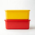 Two colorful plastic storage containers stacked on a plain background Royalty Free Stock Photo