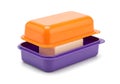 Colorful plastic container with an orange lid and purple base holding a sponge Royalty Free Stock Photo