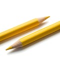 Two yellow pencils with sharpened tips resting against a plain background Royalty Free Stock Photo