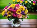 A vase filled with colorful flowers on a wooden table. Royalty Free Stock Photo