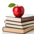 A red apple placed atop a stack of colorful books symbolizing education and knowledge Royalty Free Stock Photo