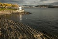 Oslo - the fjord and its dark waters, sunlit shore. Royalty Free Stock Photo