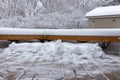 Snow shoveled wooden deck