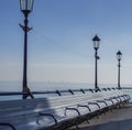 Eastbourne pier, East Sussex, England - benches and lampposts.